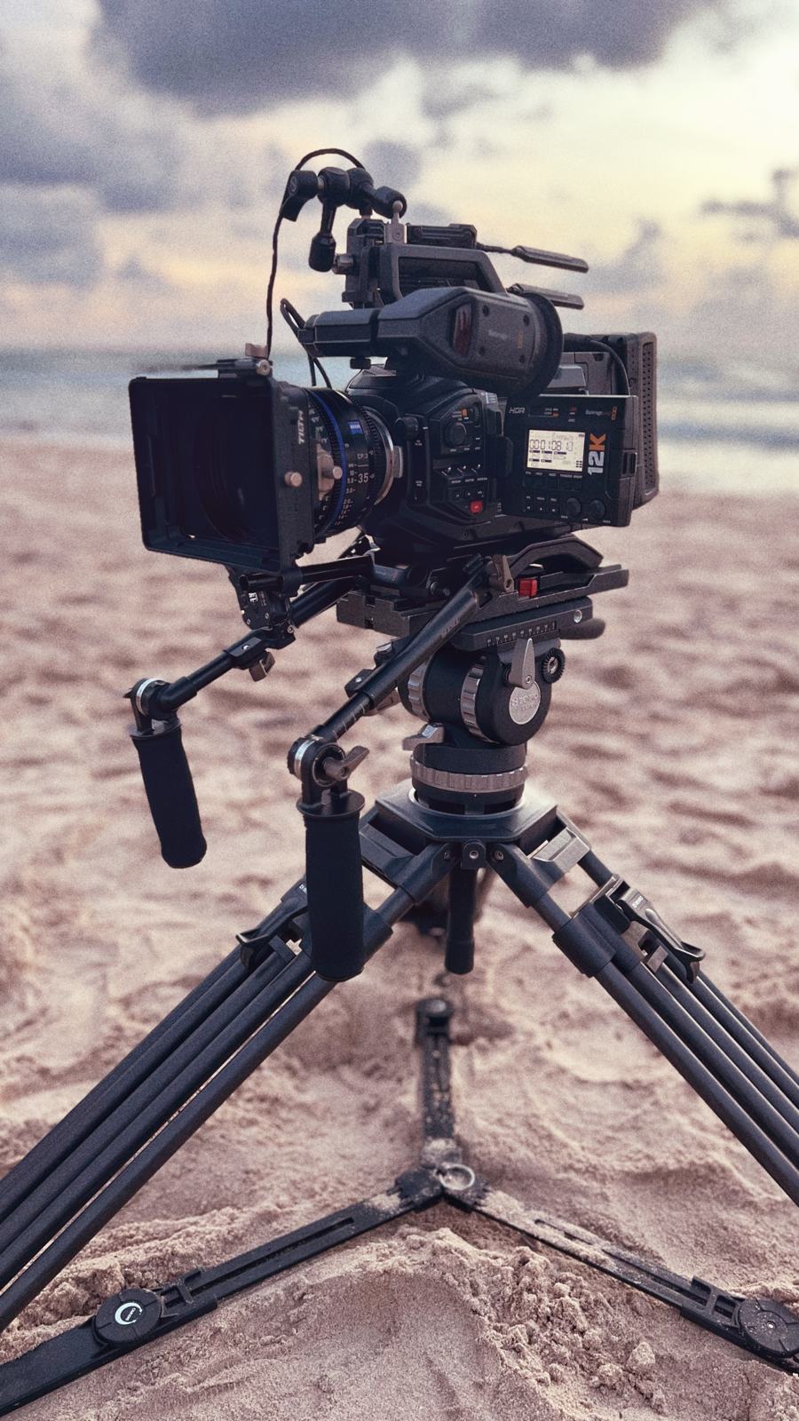 A cinema camera rig on a tripod on location
