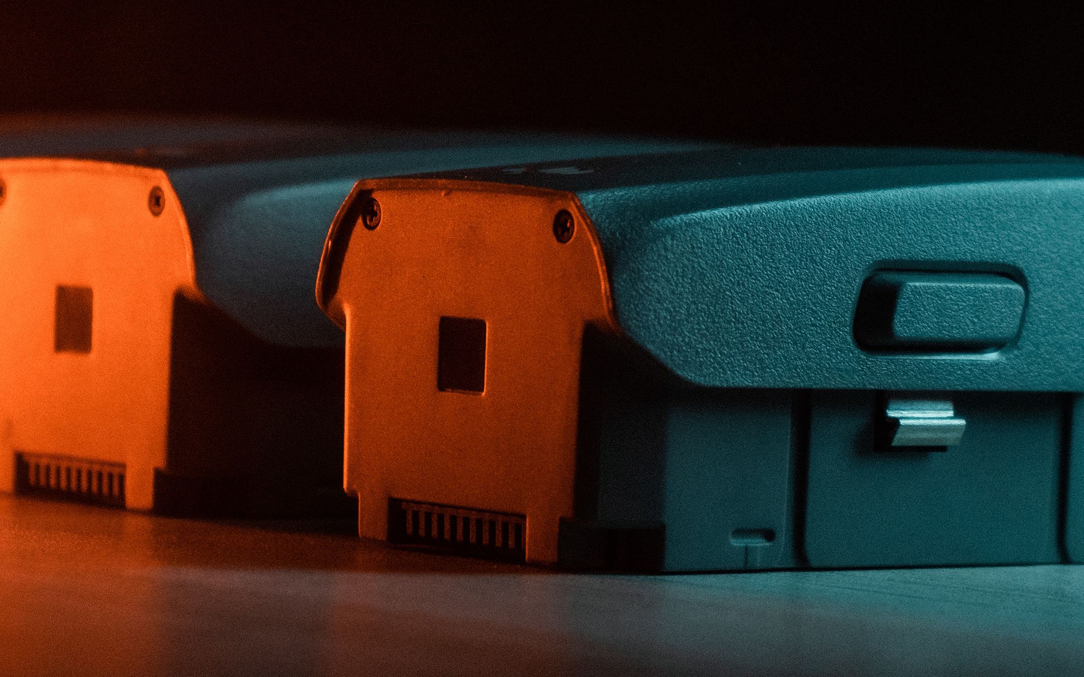 Camera batteries lit in orange and teal